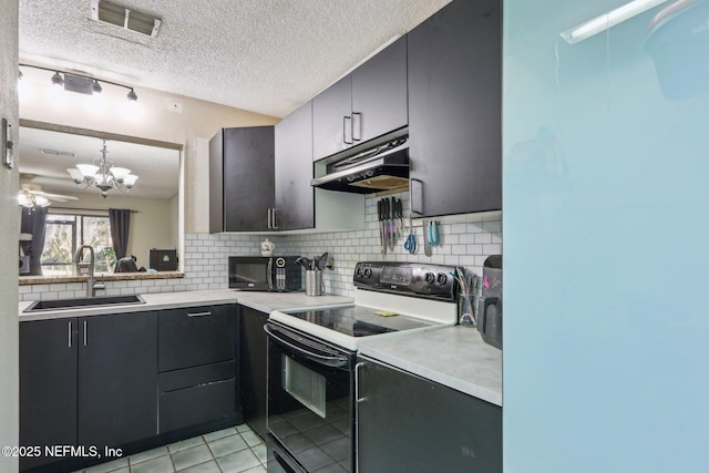 kitchen featuring pendant lighting, sink, decorative backsplash, and black appliances