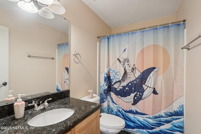 bathroom with a shower with curtain, vanity, toilet, and a textured ceiling