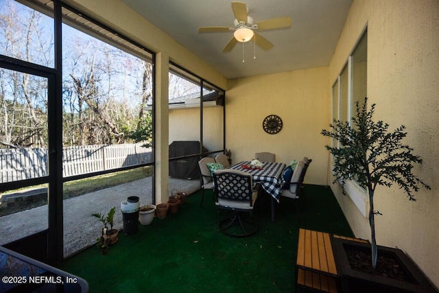 sunroom featuring ceiling fan