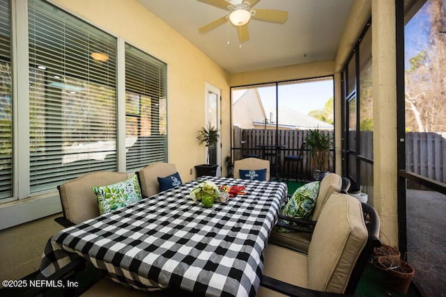 sunroom / solarium featuring ceiling fan