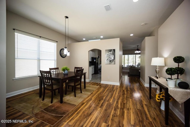 dining room with dark hardwood / wood-style flooring and ceiling fan