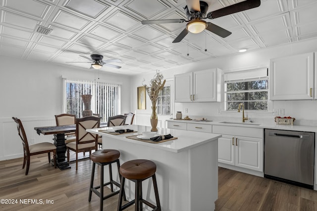 kitchen featuring sink, white cabinetry, dark hardwood / wood-style floors, a center island, and stainless steel dishwasher