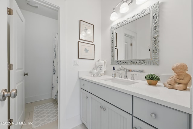 full bath featuring a shower with curtain, vanity, and tile patterned floors