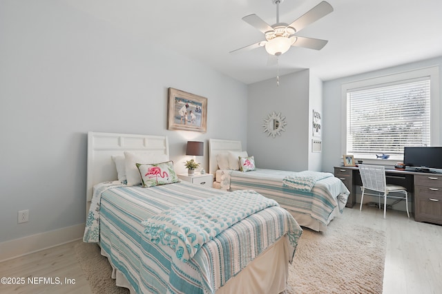 bedroom featuring light wood-type flooring, baseboards, and a ceiling fan