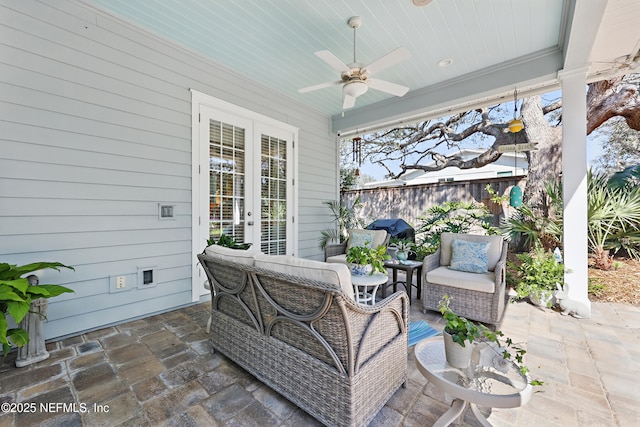 view of patio featuring an outdoor hangout area, french doors, fence, and a ceiling fan