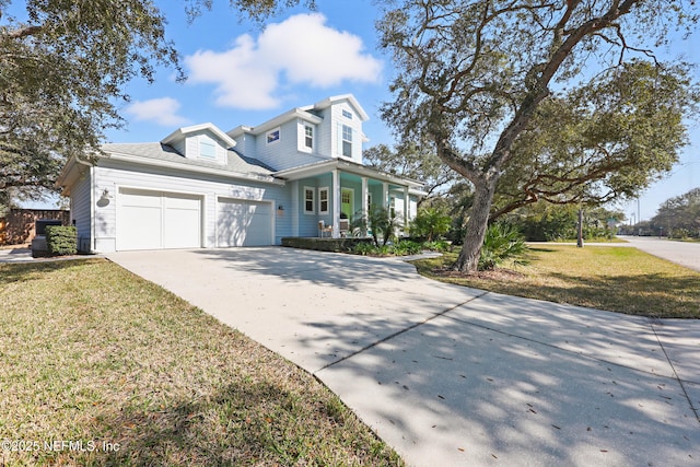 view of front of home featuring an attached garage, a porch, a front lawn, and concrete driveway