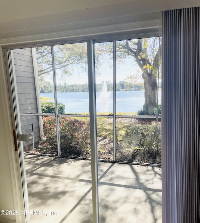 doorway to outside featuring a water view