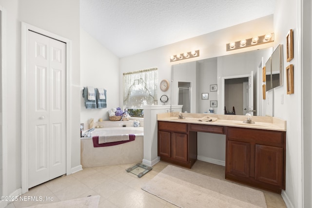 bathroom with lofted ceiling, vanity, a textured ceiling, tile patterned floors, and separate shower and tub