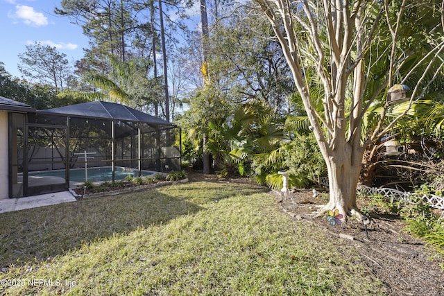 view of yard featuring glass enclosure