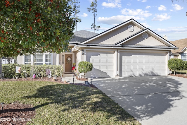 view of front of house with a garage and a front lawn