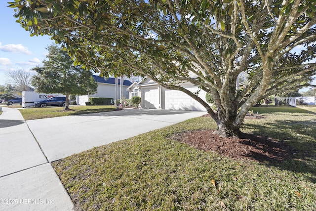 view of front facade with a garage and a front lawn