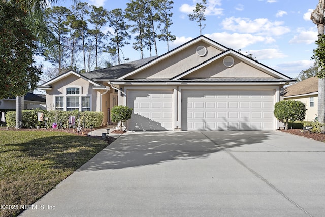 ranch-style house with a garage and a front lawn