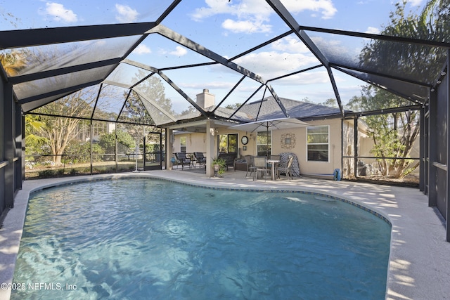 view of pool featuring a patio area and glass enclosure