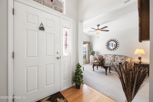 foyer entrance with hardwood / wood-style flooring and ceiling fan