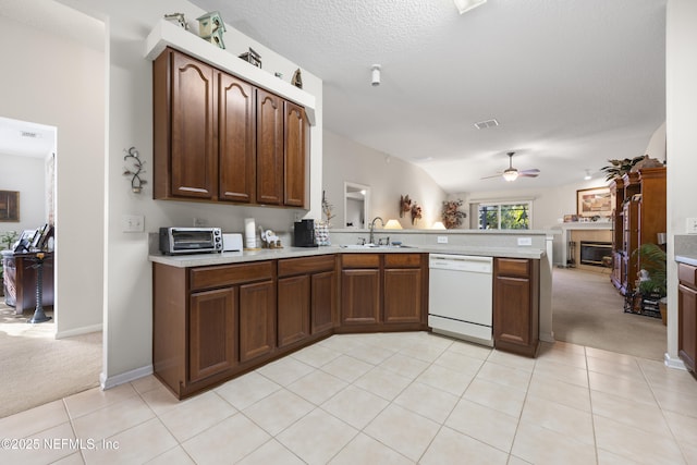 kitchen featuring light colored carpet, dishwasher, sink, and kitchen peninsula