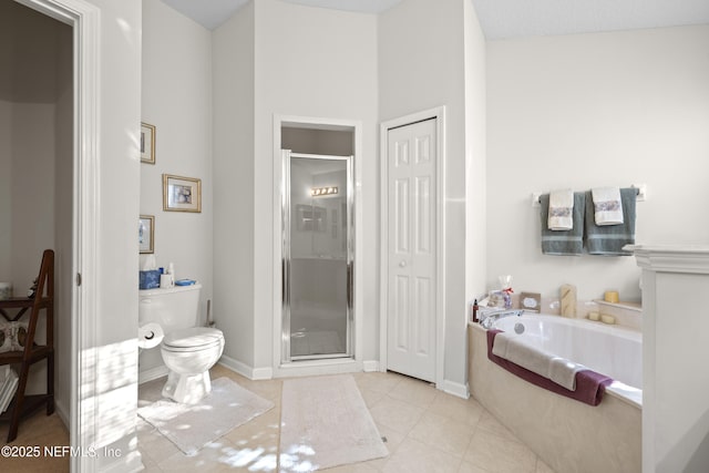 bathroom featuring tile patterned flooring, plus walk in shower, and toilet