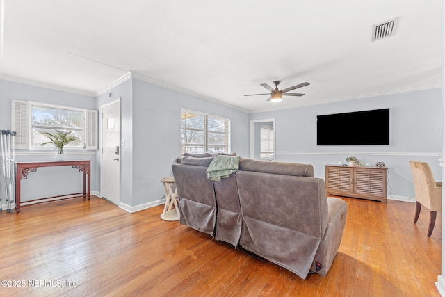 living room featuring crown molding, ceiling fan, and light wood-type flooring