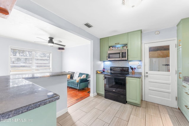 kitchen with tasteful backsplash, dark stone counters, ceiling fan, green cabinetry, and black range with electric stovetop