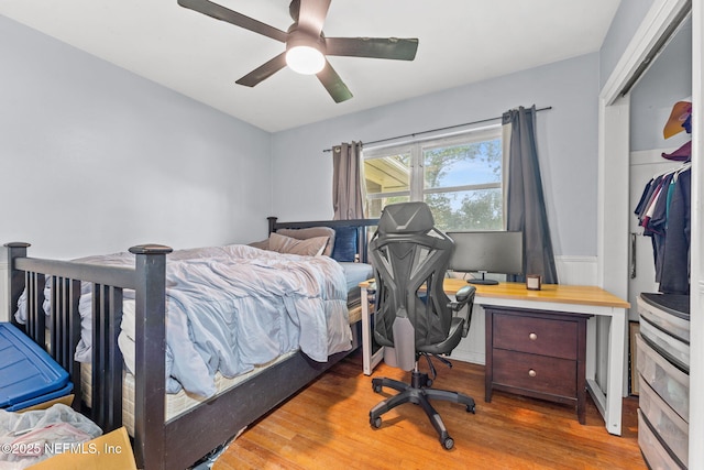 bedroom featuring wood-type flooring, ceiling fan, and a closet