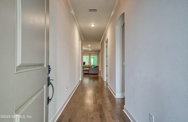 corridor featuring dark hardwood / wood-style flooring and ornamental molding