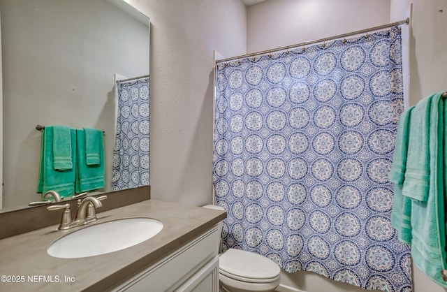 full bathroom with shower / bathtub combination with curtain, vanity, and toilet