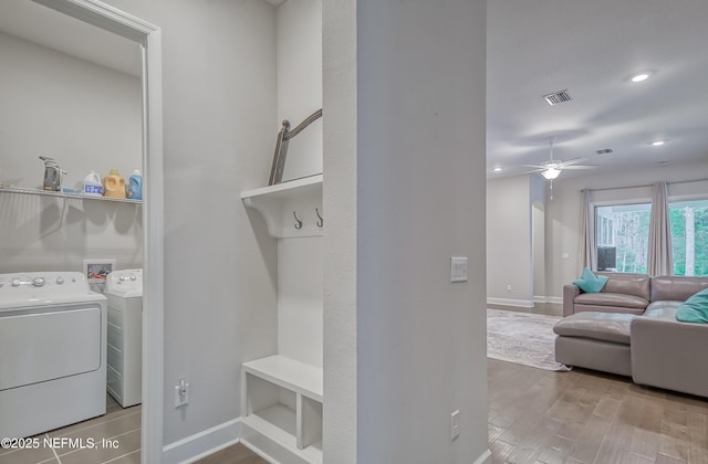 laundry area with ceiling fan, wood-type flooring, and washer and clothes dryer