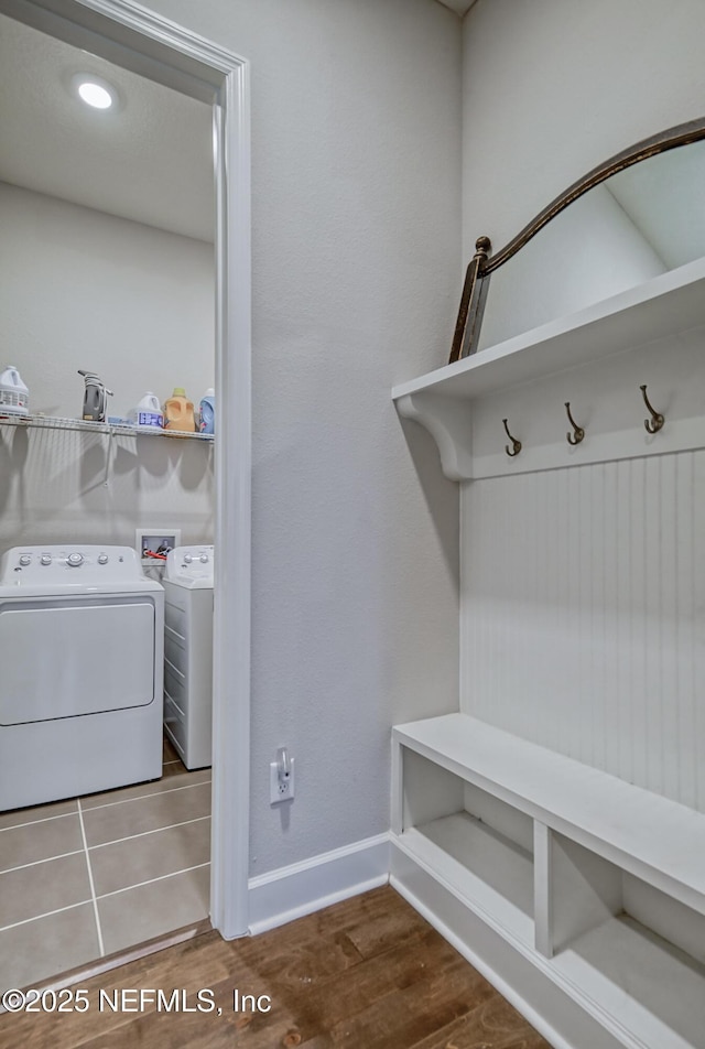 mudroom featuring wood-type flooring and separate washer and dryer