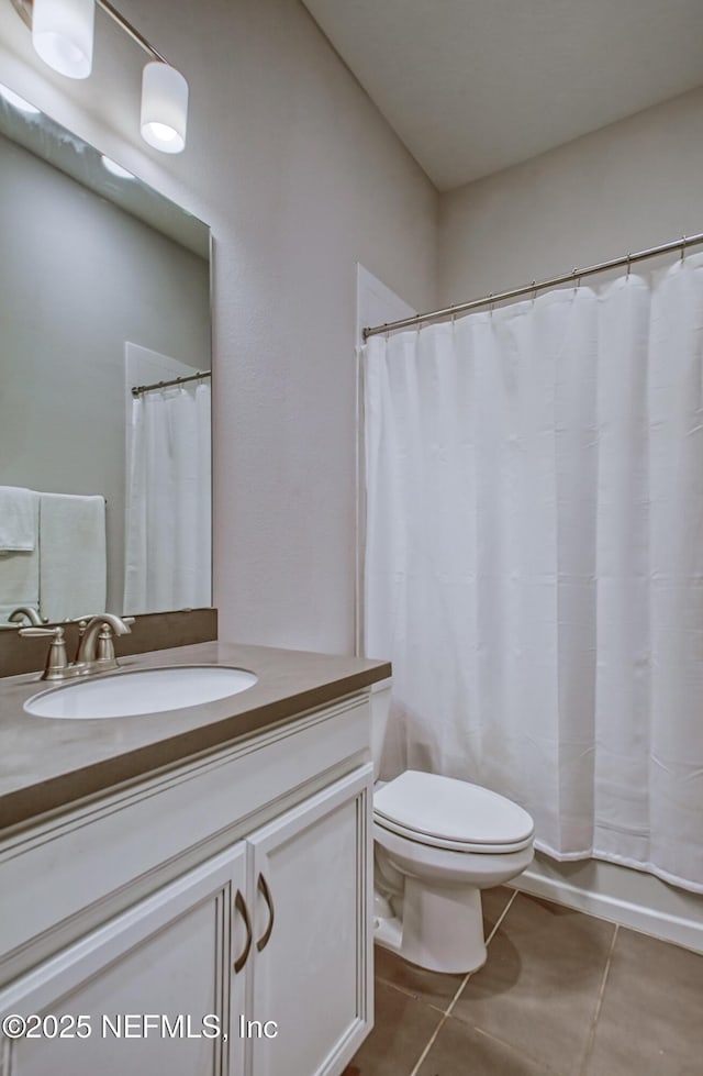 full bathroom featuring vanity, tile patterned floors, toilet, and shower / bathtub combination with curtain