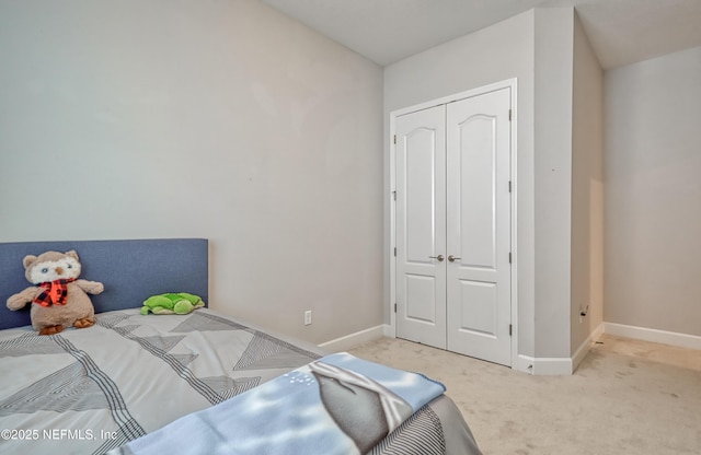 bedroom with light colored carpet and a closet