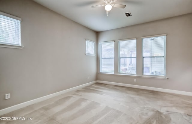 spare room featuring light carpet and ceiling fan