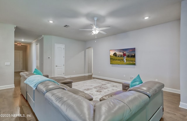 living room featuring wood-type flooring and ceiling fan