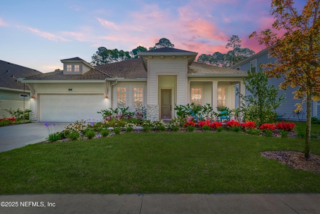 view of front of home featuring a garage and a yard