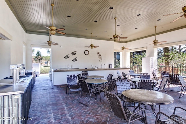 view of patio featuring ceiling fan and an outdoor wet bar