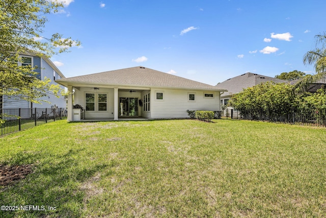 rear view of house with a fenced backyard, a patio area, ceiling fan, and a lawn