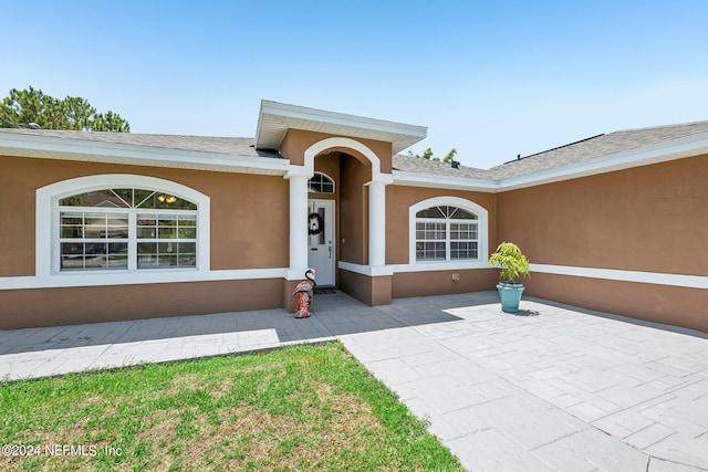 doorway to property with a patio area