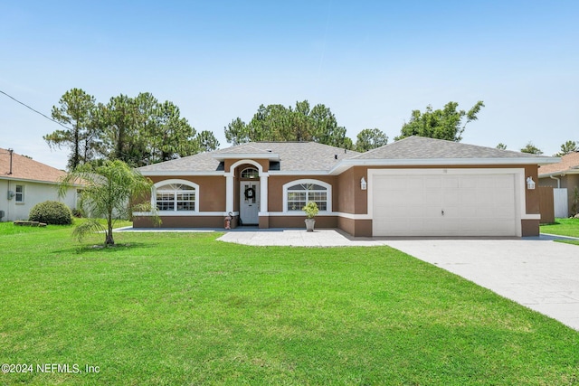 ranch-style home featuring a garage and a front lawn