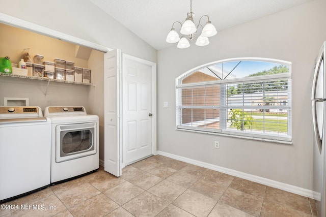 laundry room with light tile patterned floors, a textured ceiling, independent washer and dryer, and a chandelier