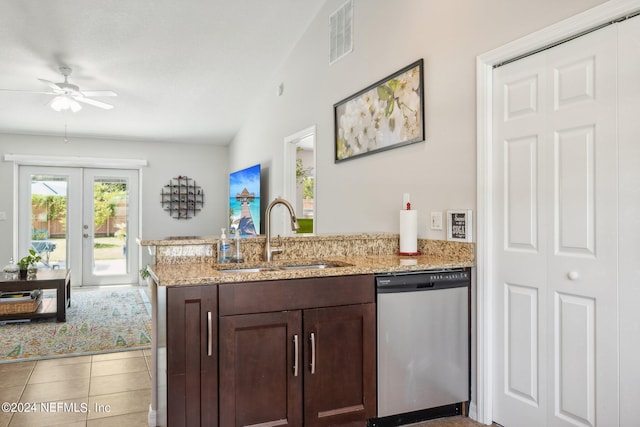 kitchen with sink, stainless steel dishwasher, light tile patterned floors, dark brown cabinetry, and light stone countertops