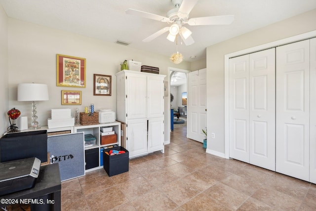 interior space with ceiling fan