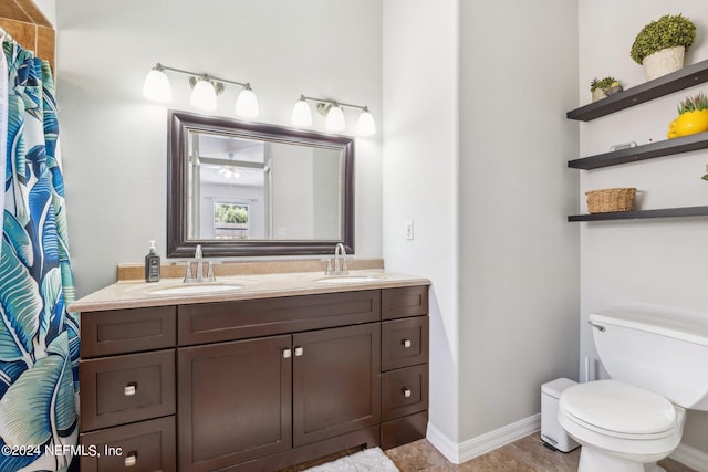 bathroom featuring vanity, toilet, and walk in shower