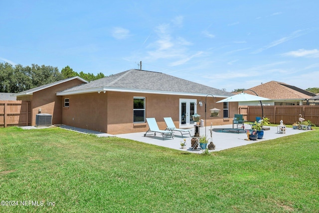 back of property featuring french doors, a lawn, a patio, and central air condition unit