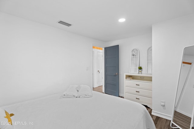 bedroom featuring dark hardwood / wood-style flooring