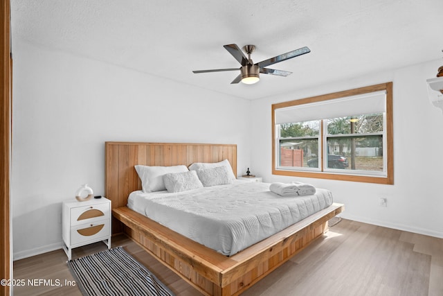 bedroom with wood-type flooring and ceiling fan