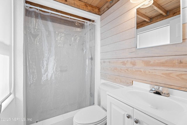 bathroom featuring toilet, wood walls, a shower with curtain, vanity, and beam ceiling