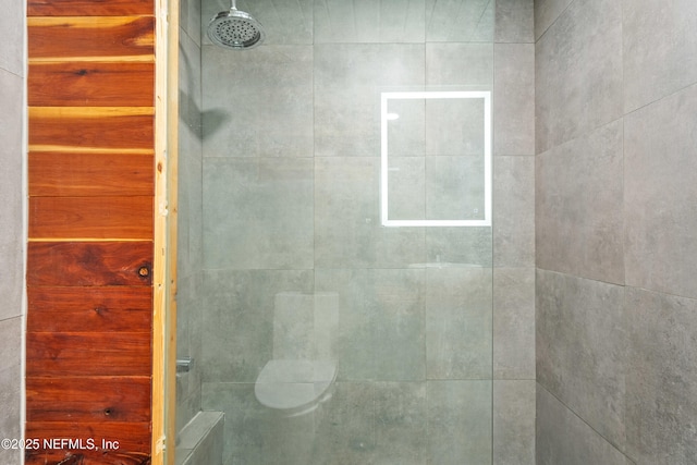 bathroom with tiled shower