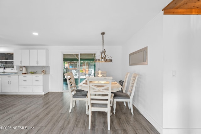 dining room featuring sink and hardwood / wood-style floors