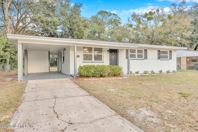 single story home featuring a carport and a front yard