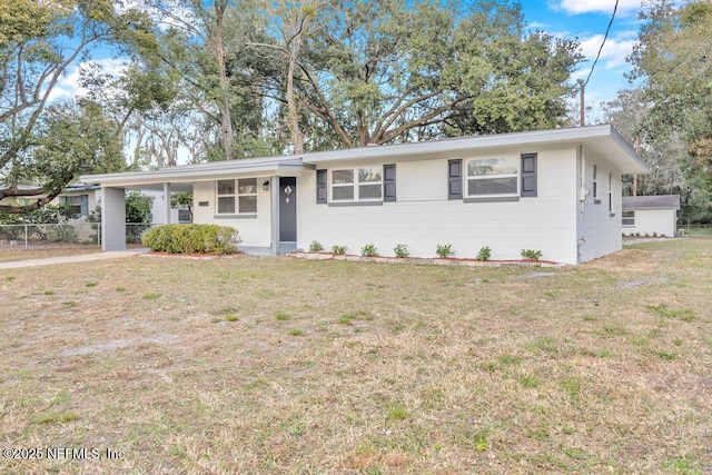 ranch-style home featuring a front yard and a carport