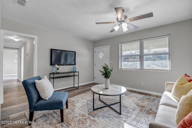 living room with ceiling fan and light wood-type flooring