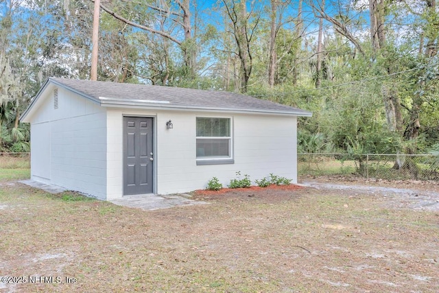 view of outbuilding featuring a yard